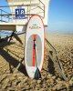 Paddle Board Leaned Up Against Lifeguard Stand